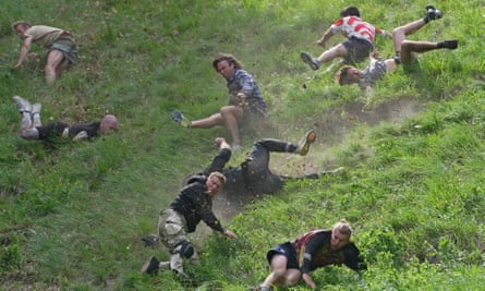 Woman wins Coopers Hill cheese rolling race despite being knocked out | Cheese